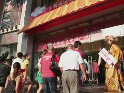 MS Shot of mall entrance and men dressing in ancient characters to attract customers / Beijing, China Stock Footage