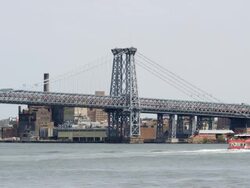 MS Manhattan Bridge and Williamsburg in BG with East River and crossing boats / New York, New York, USA Stock Footage