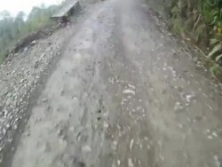 A bicyclist speeds along a rough dirt track in the Bolivian mountains. Stock Footage