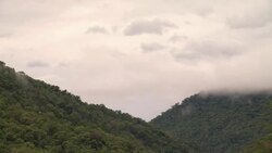 Clouds roll over forested hills. Stock Footage