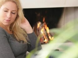 Female in front of fireplace looking to camera Stock Footage