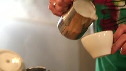 Pouring milk in coffee from barista Stock Footage