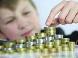 boy puts coins from piggy bank Stock Footage