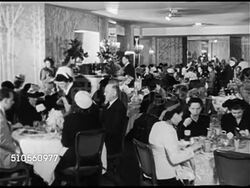 1948:  SAN FRANCISCO, CALIFORNIA: Angled WS Fairmont Hotel w/ traffic FG. UPSCALE DINING: Dining room. Women in hats dining w/ men in suits. Dessert tray in front of bottles of champagne. Prepared salads on ice, CU Fruit salad w/ cottage cheese. Instructional Video