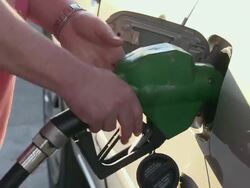 CU, Man filling car at Manhattan gas station, close-up of gas nozzle and hand, New York City, New York, USA Stock Footage