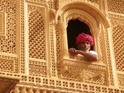 Rajasthani senior man sitting at window, Amar Sagar Jain Temple, Jaisalmer, Rajasthan, India Stock Footage