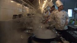 Chefs prepare food in a restaurant kitchen in Beijing. Stock Footage