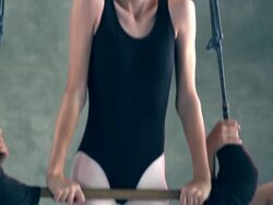 MS TU TD PAN young ballerina dancer girl pulls  herself up into ballet trapeze while trapeze is steadied by two other young ballerinas in ballet pose / Rancho Mirage, California, United States  Stock Footage