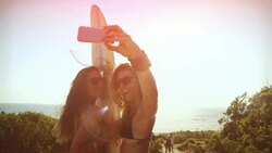 Surfer girls taking a selfie Stock Footage