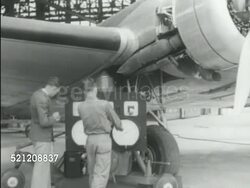 MOT 1939: OHIO: WRIGHT FIELD: Â“Wright Field, US ArmyÂ” chain-link fence sign w/ barbed-wire strips top. WS Two US Army Air Corps mechanics, engineers w/ equipment next to large twin-engine aircraft parked outside hangar, MS Men using testing equipment. Instructional Video