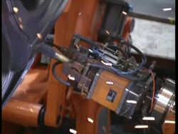 CU high angle, Robots working on cars in factory production line Stock Footage