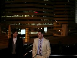 MS TD Two well dressed young man standing together on modern convertible car at night in urban area laughing and smiling / Minneapolis, Minnesota, United States Stock Footage