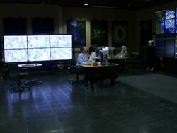 Large array of monitors pan to workers at computer stations Texas Advance Computer Center Stock Footage