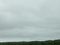 A paramotor flying in a cloudy sky Stock Footage