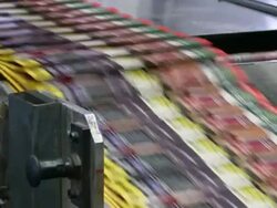 CU Newspapers on conveyor belt in gravure printing office / Itzehoe, Schleswig-Holstein, Germany  Stock Footage