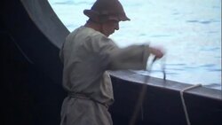A sailor handles ropes at the side of a ship. Stock Footage