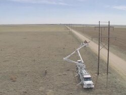 WS ZO AERIAL Energy workers preparing to adjust power line, from tsafety of two cherry pickers / Hooker, OK, USA Stock Footage