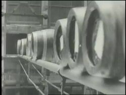 Beer barrels roll along a conveyor belt. News Clip