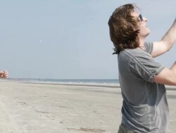   MS SLO MO Young couple flying kite at beach / Isle of Palms, South Carolina, USA Stock Footage