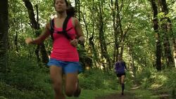 Ultra marathon runner running outdoors in the woods Stock Footage