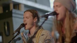 Two young men sing and play guitar in touring rock band at Austin music festival Stock Footage