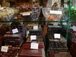 Slow dolly move across chocolate in shop in Bruges, Belgium Stock Footage