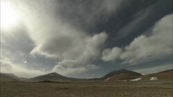 Ominous clouds streak above dry hills in Tibet. Stock Footage