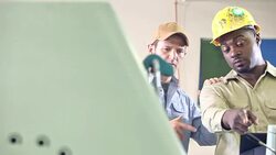 Two men working in printing shop with equipment Stock Footage