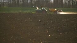 Tractor spray fertilize on field with chemicals in agriculture field. Stock Footage