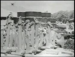 1940s: UNITED STATES NAVY PORT: WS PAN Stockpile of various U.S. Naval yard equipment, including oil drums, anchors, chains (metals), PAN incomplete tanks in tank yard, incomplete landing crafts in harbor. WWII, World War II, Pacific Front Instructional Video
