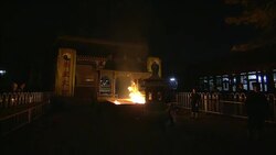 A fire burns in a temple where participants toss in incense sticks. Stock Footage