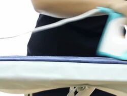 Crane shot: Jean ironing Stock Footage