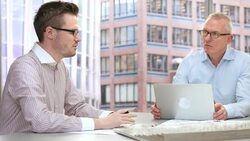 Three architects discussing the project in a meeting Stock Footage