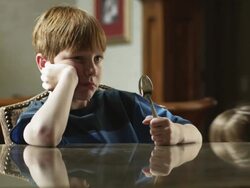 MS Bored boy (10-11) sitting at table, holding spoon, American Fork, Utah, USA Stock Footage