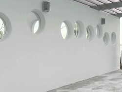 Young man with a towel walking from sea past wall and camera Stock Footage