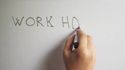 Hand writing title 'WORK HARD DREAM BIG' on white board Stock Footage