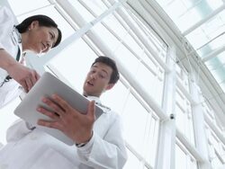  LA Doctors studying an electronic tablet and talking / Seattle, Washington, United States Stock Footage