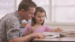 Male teacher working with his elementary school student in class Stock Footage