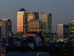 "WS ZO T/L View of Canary Wharf at night to high rise offices Barclays Bank HSBC CITI JP Morgan construction cranes and Old Royal Naval College with clear sky / London, Greater London, United Kingdom" Stock Footage