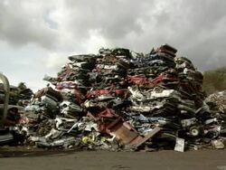 MS Large mountain of cars and bulldozer passing by / Tacoma, Washington, United States Stock Footage
