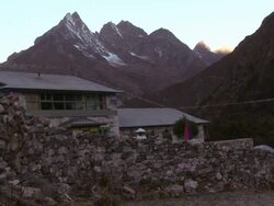 Stone wall and buildings in the shadow of Himalayan peaks. Stock Footage