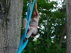 MS TS Woman hangs from fabric and spinning around in circles while hanging from large trees in tropical paradise / Montezuma, Puntarenas, Costa Rica Stock Footage