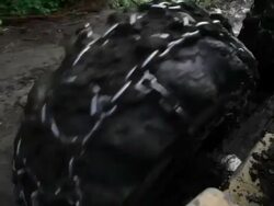 Close up of wheels of skidder as it drives through the mud. Stock Footage