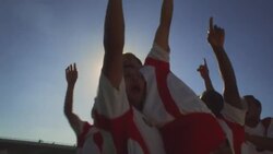 Soccer teammates pump fists in the air in celebration. Stock Footage