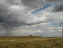 Wind farm on prairie with very dramatic clouds in sky. Stock Footage