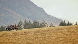 SLO MO Two cowboys galloping up the mountain Stock Footage