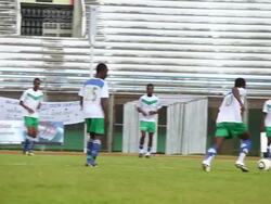 MS TS PAN Young footballers going through series of training exercises and routines in warm up for match / Freetown, Sierra Leone Stock Footage