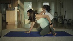 Pregnant mother doing yoga in her home with her toddler Stock Footage