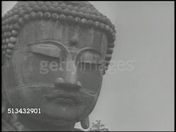 1946: JAPANESE BUDDHISM: VS Various people observing large Buddha statue, various United States G.I.'s walking in courtyard w/ pagoda tower BG. VS American soldiers visiting shrines & temples, placing incense into large urn. Religion, culture Instructional Video