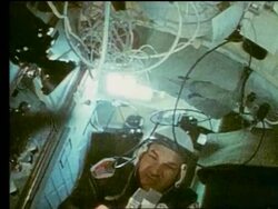 Soviet cosmonaut handing camera to astronaut Stock Footage